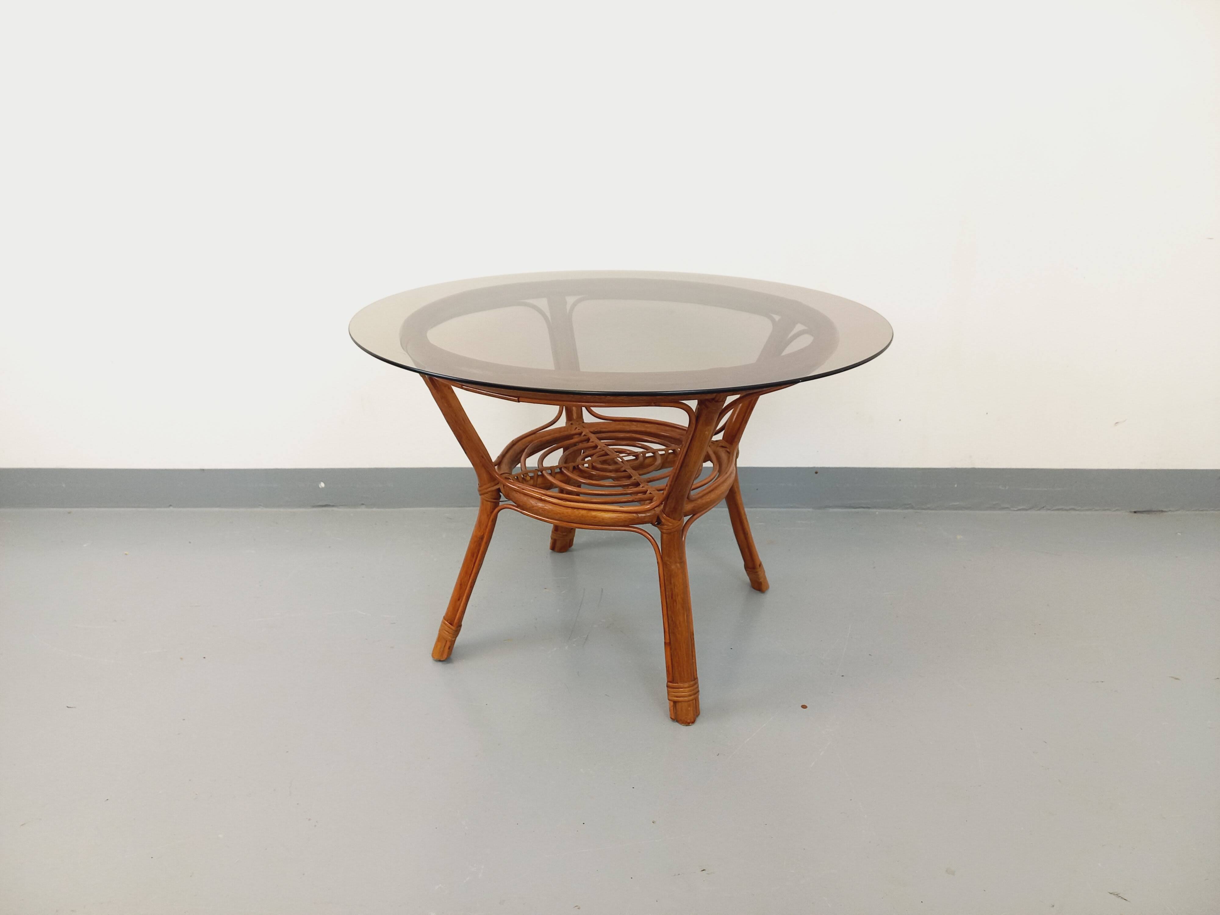 Vintage round smoked glass and rattan coffee table from the 70s