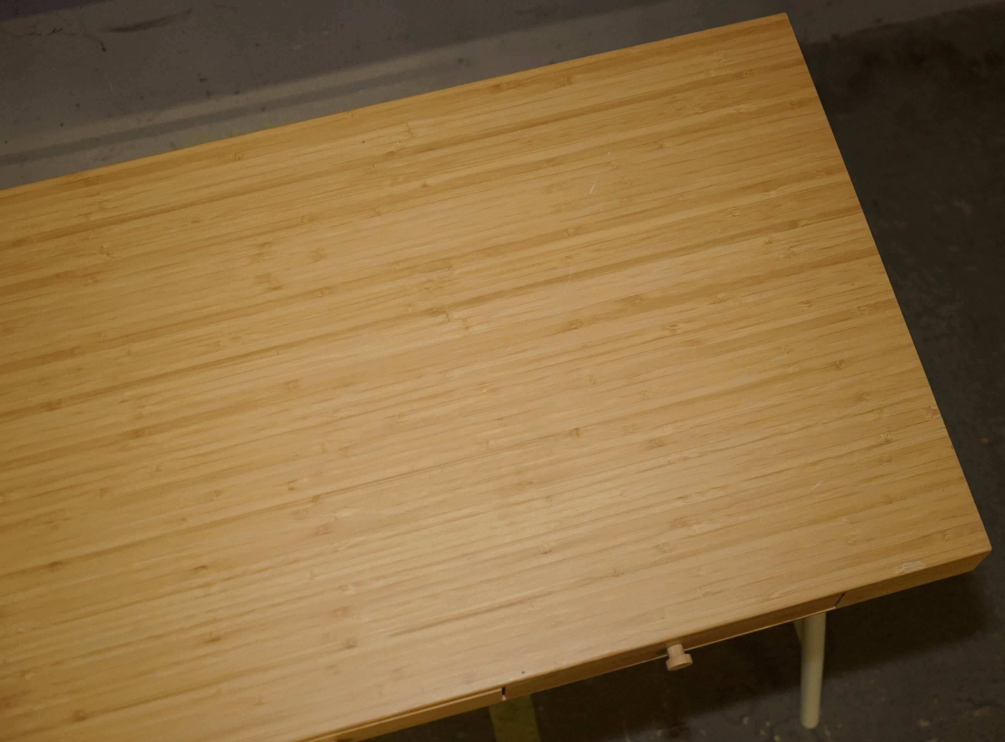 Small bamboo desk with three drawers.