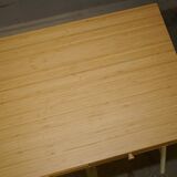 Small bamboo desk with three drawers.