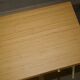 Small bamboo desk with three drawers.