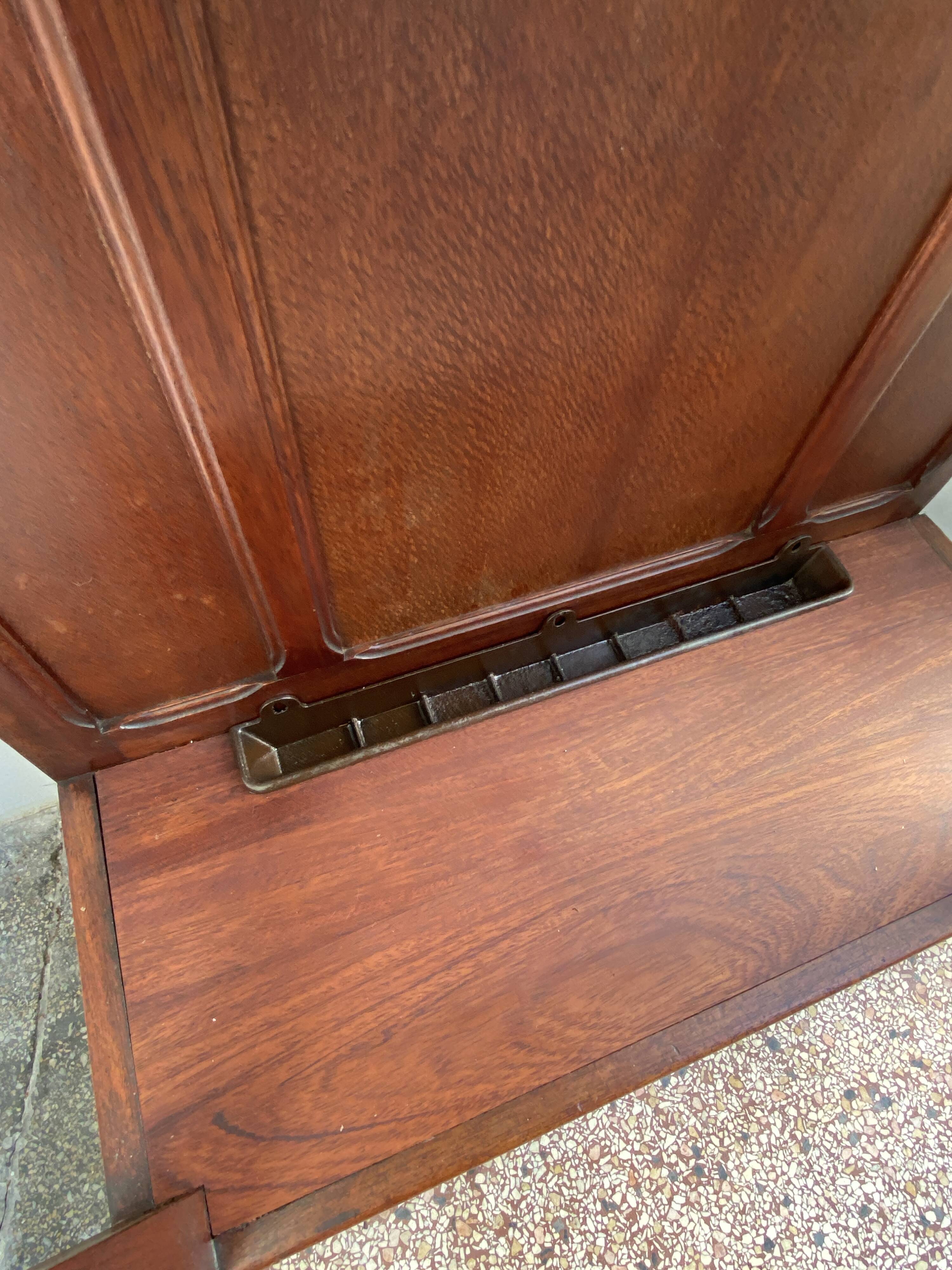 Antique wooden coat rack with mirror and shelf.