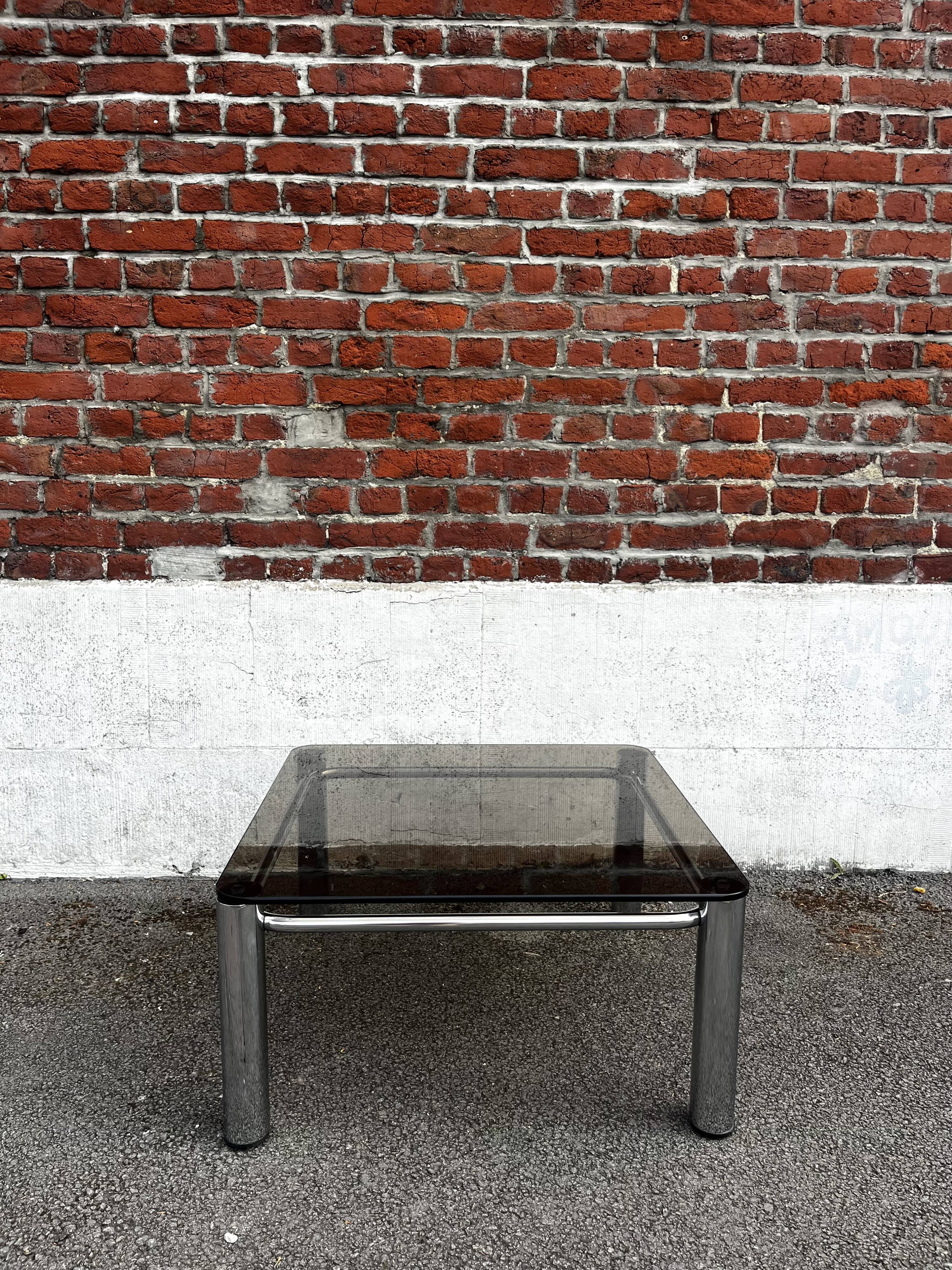 Vintage smoked glass coffee table with chrome structure.
