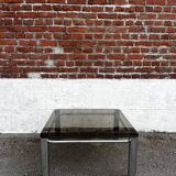 Vintage smoked glass coffee table with chrome structure.