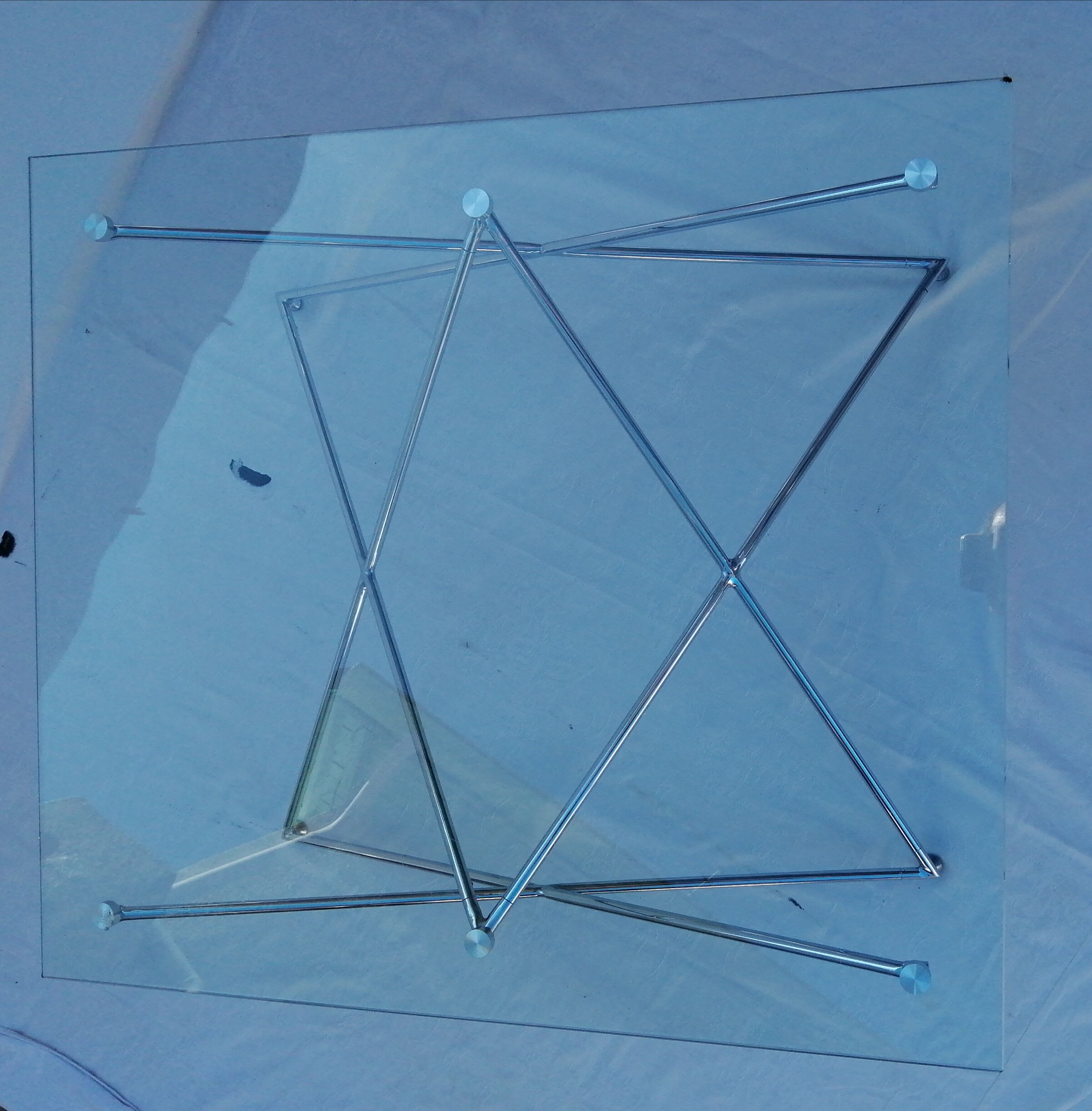 Tempered glass coffee table, intertwined legs design