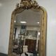 Large carved and gilded wooden mirror, rectangular in shape.