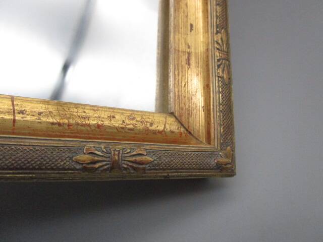 Small old mirror in wood and gilded stucco