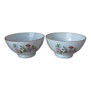 Two speckled beige ceramic bowls for breakfast with a pink flower design.