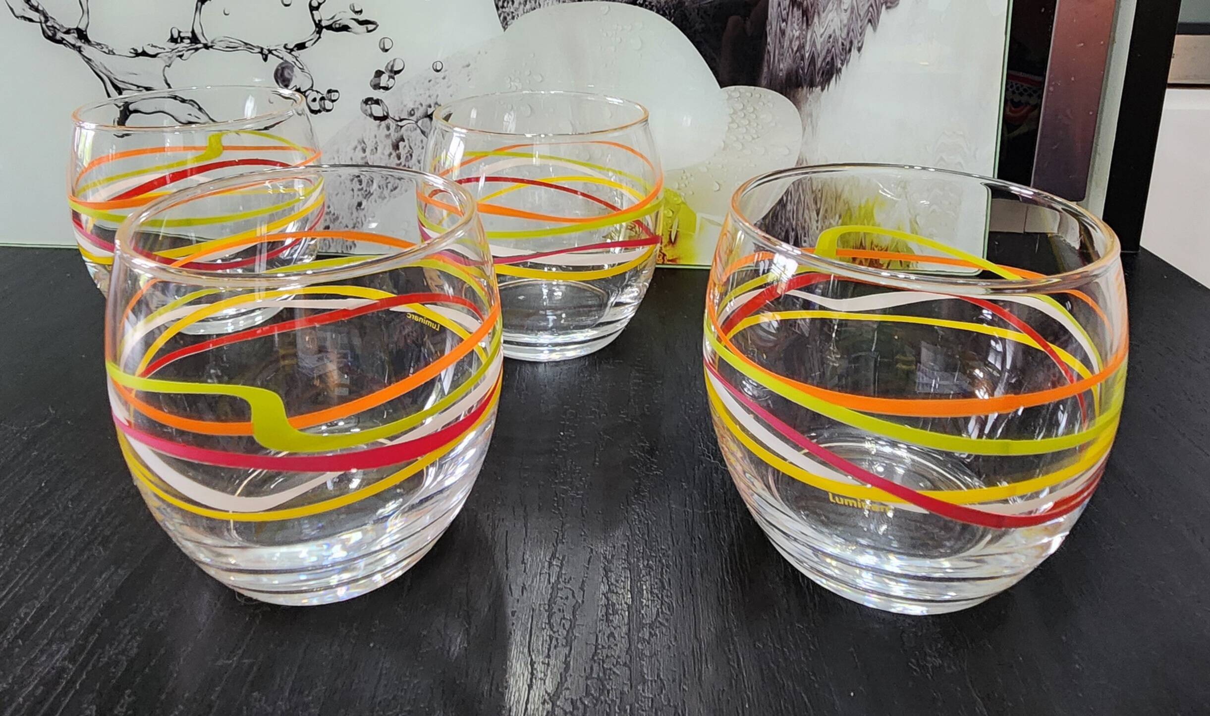 4 vintage Luminarc water glasses with coloured spiral line patterns.