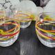 4 vintage Luminarc water glasses with coloured spiral line patterns.