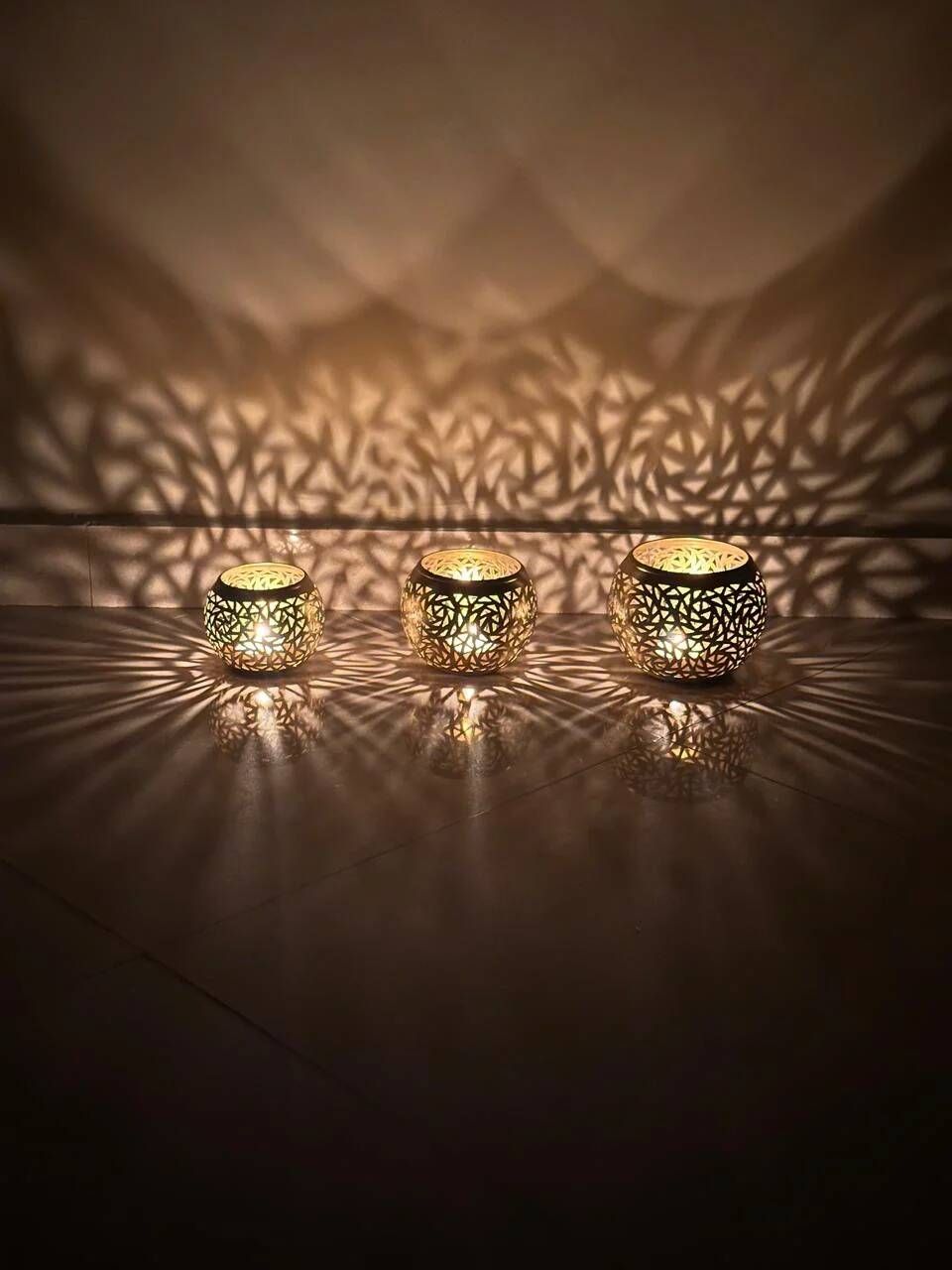 Set of 3 handmade brass candle holders with an openwork pattern.