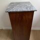Vintage bedside table in the shape of a wooden column and a gray marble top