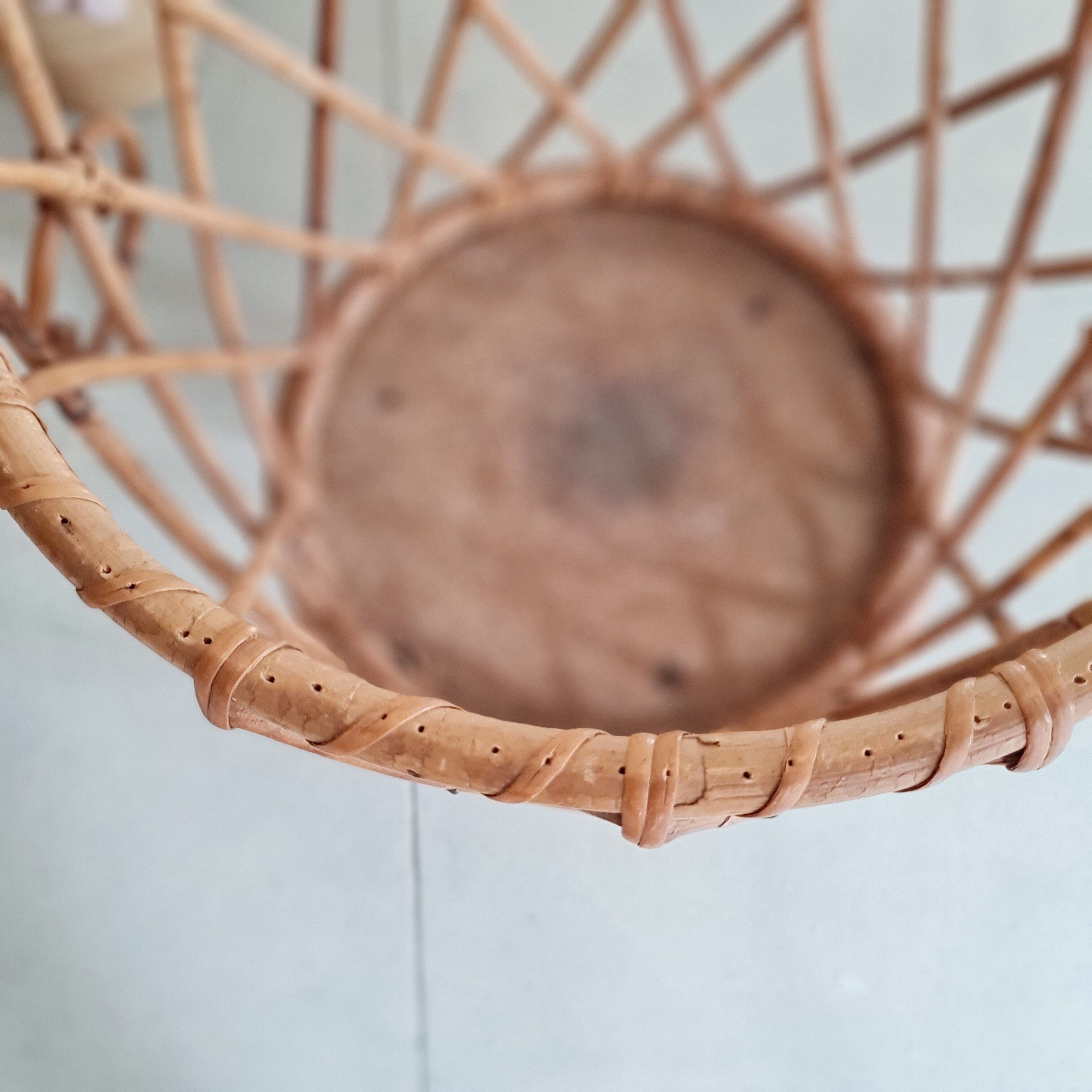 Old tripod rattan plant holder