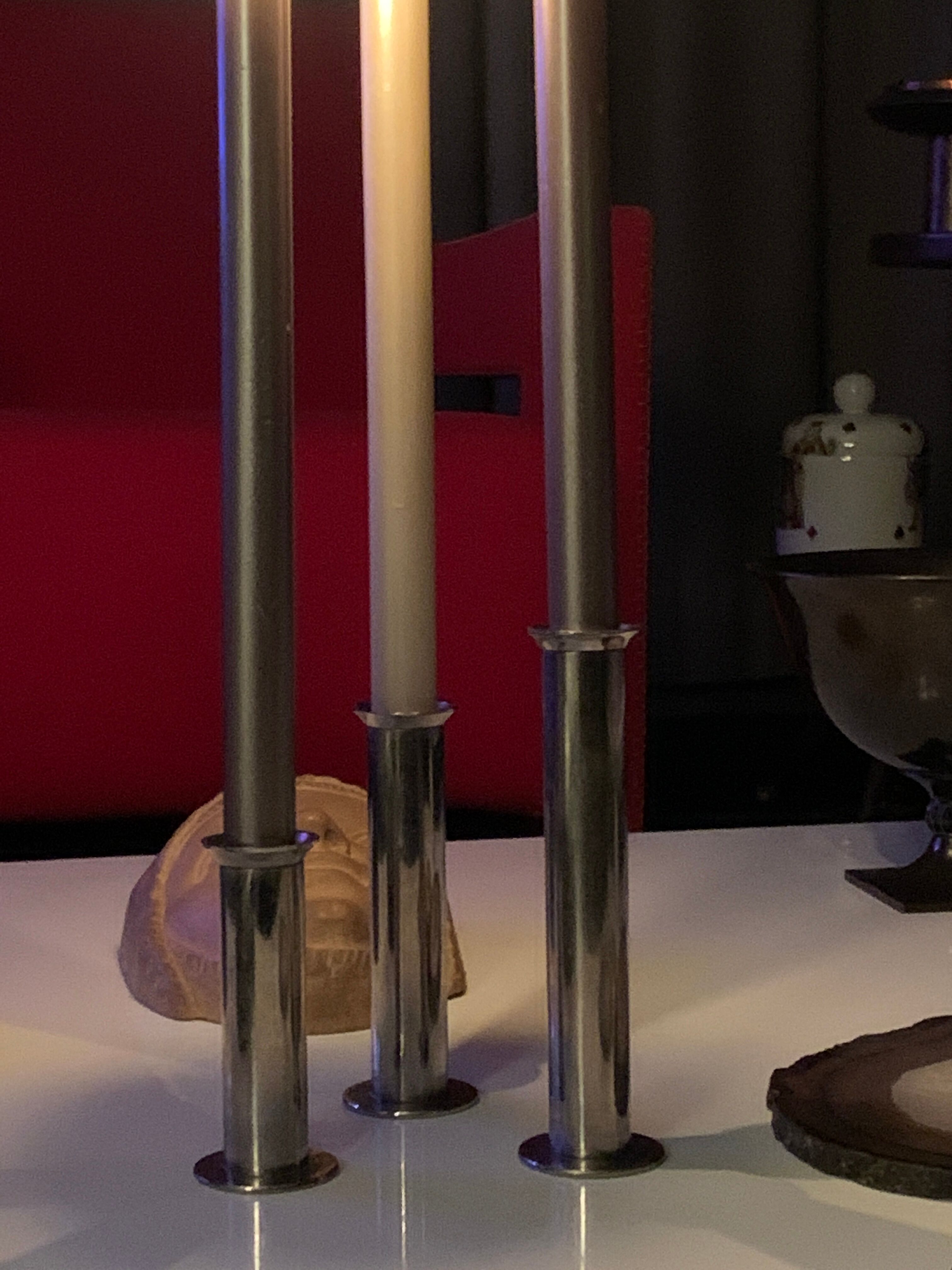 Three silver metal candle holders