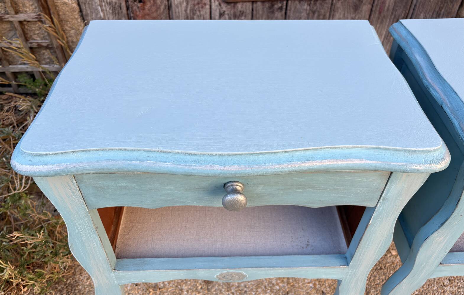 Pair of patinated lagoon blue bedside tables, early 20th century, with curved legs.