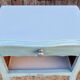 Pair of patinated lagoon blue bedside tables, early 20th century, with curved legs.