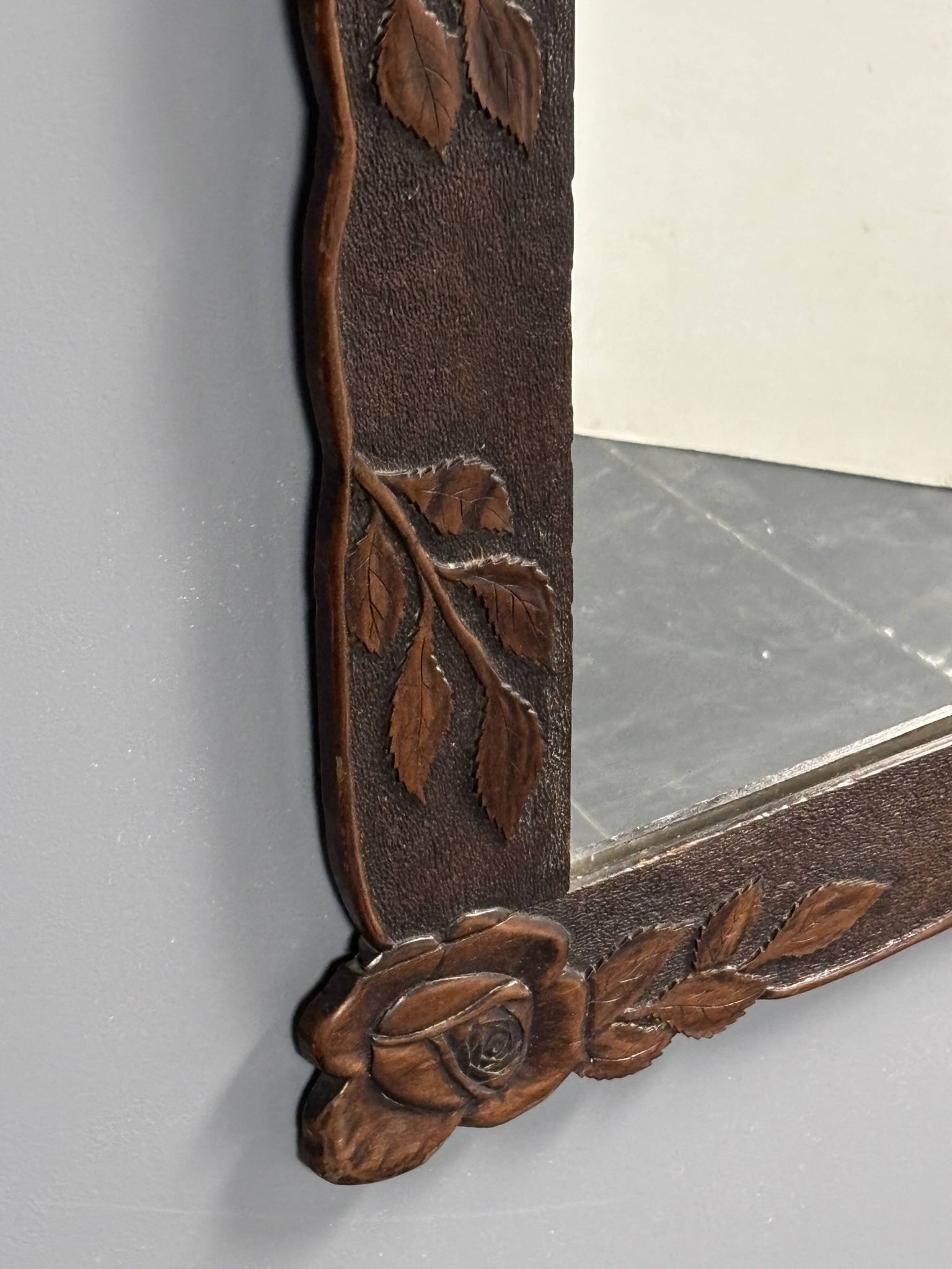 Arts & Crafts hand-carved wall mirror with floral roses, early 20th century