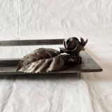 Vintage wall mirror in varnished steel decorated with a rose in relief