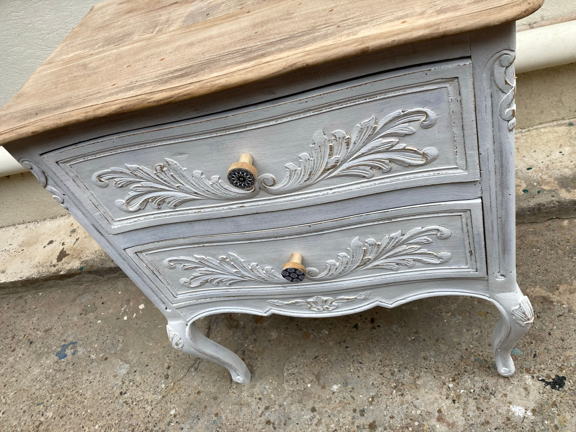 Adorable small chest of drawers or weathered white console.