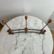 Wall-mounted coat rack in wrought iron with turned wooden knobs.