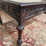 Middle table in a sculpted Louis XIII style living room.