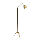 Foot of articulated golden brass floor lamp