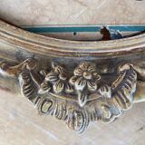 Old oval frame in wood and gilded stucco