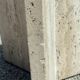 Dining table in travertine, glass top and brass (c.1980)