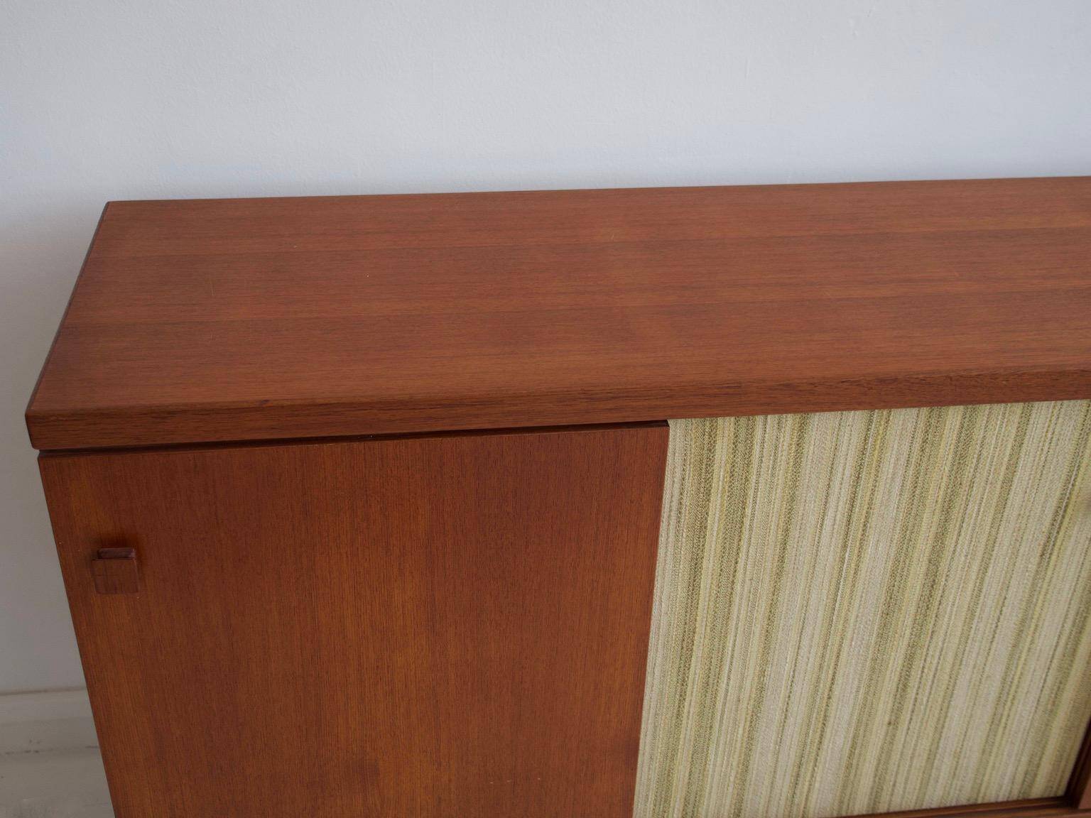 Buffet Ilmari Tapiovaara in teak with fabric and brass details.