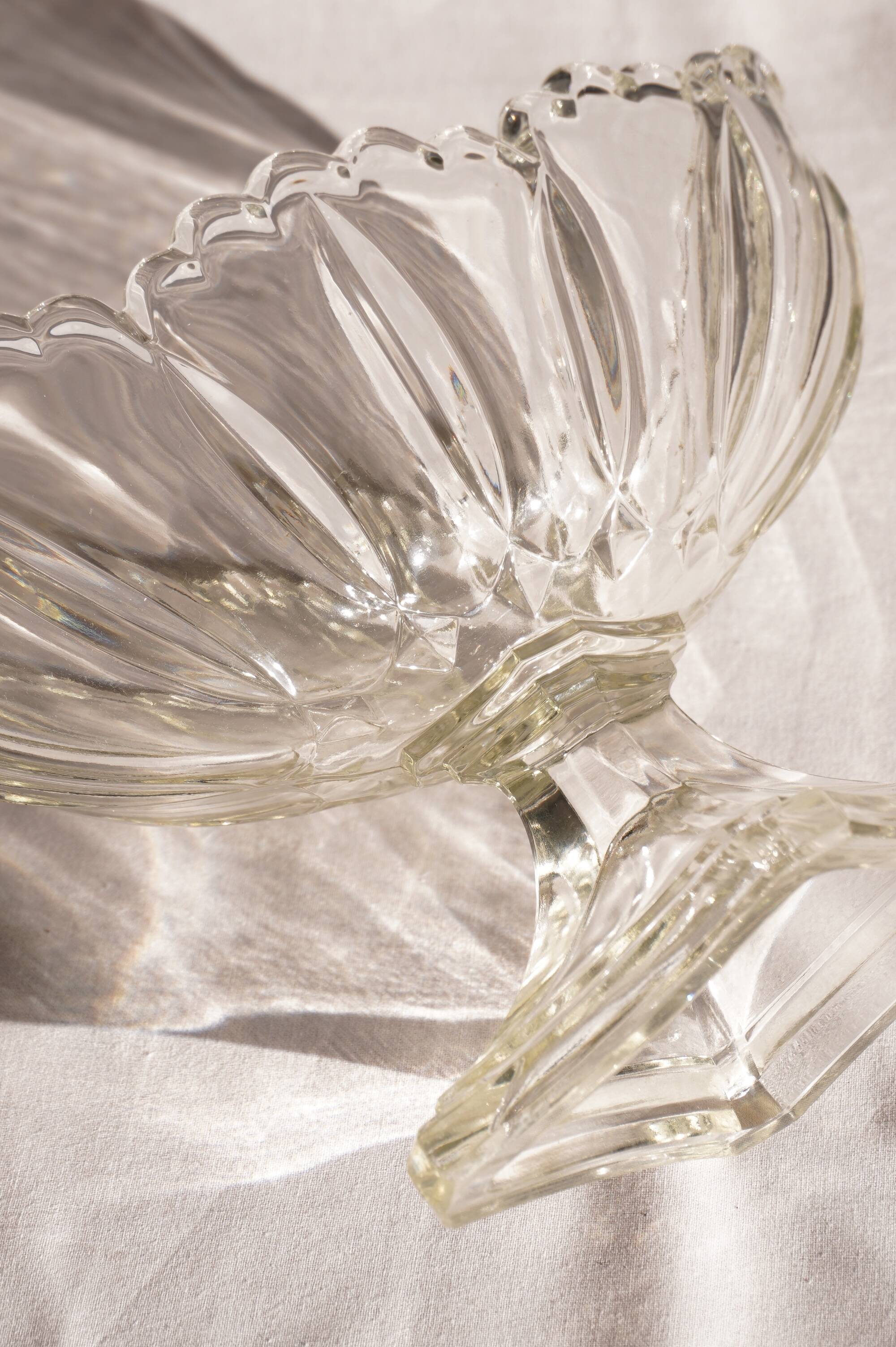 Oval glass fruit bowl on a stand.