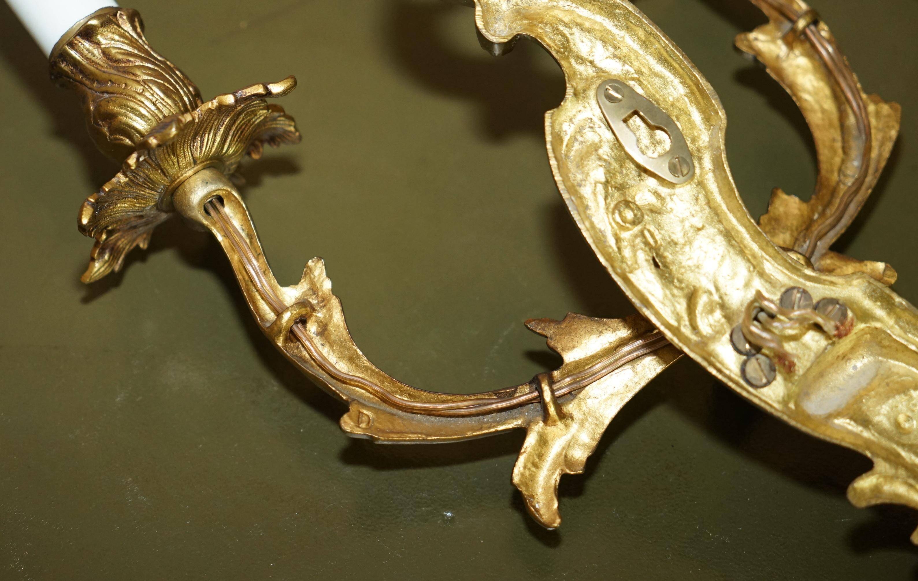 Pair of antique French wall sconces, gilded and bronzed, from the 1920s.