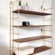 Wood-coloured metal string shelf and gold double studs 1960
