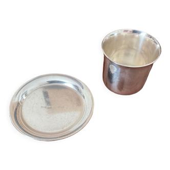 Cup and silver metal saucer