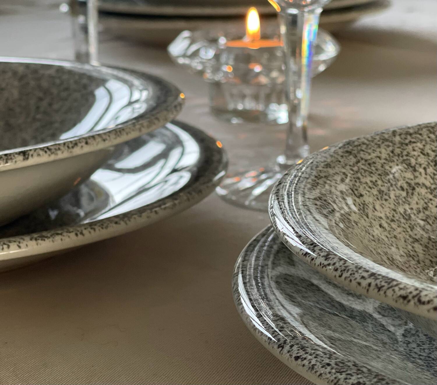 12 speckled ceramic plates.