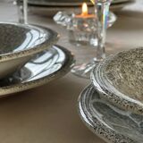 12 speckled ceramic plates.