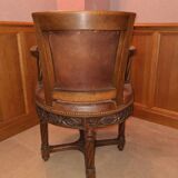Antique swivel armchair in carved wood and patinated leather – neo-Renaissance style
