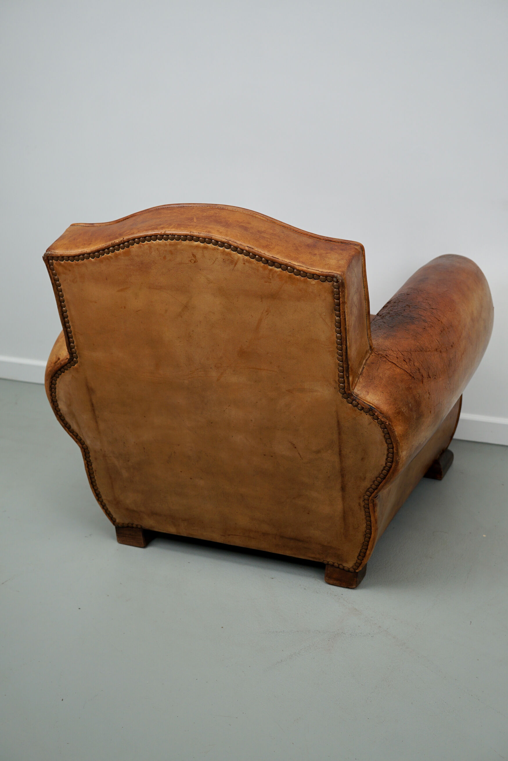 French moustache back cognac-colored leather club chair, 1940s