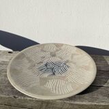 Round ethnic handmade fish dish