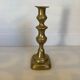 Brass candlestick with a rectangular base.