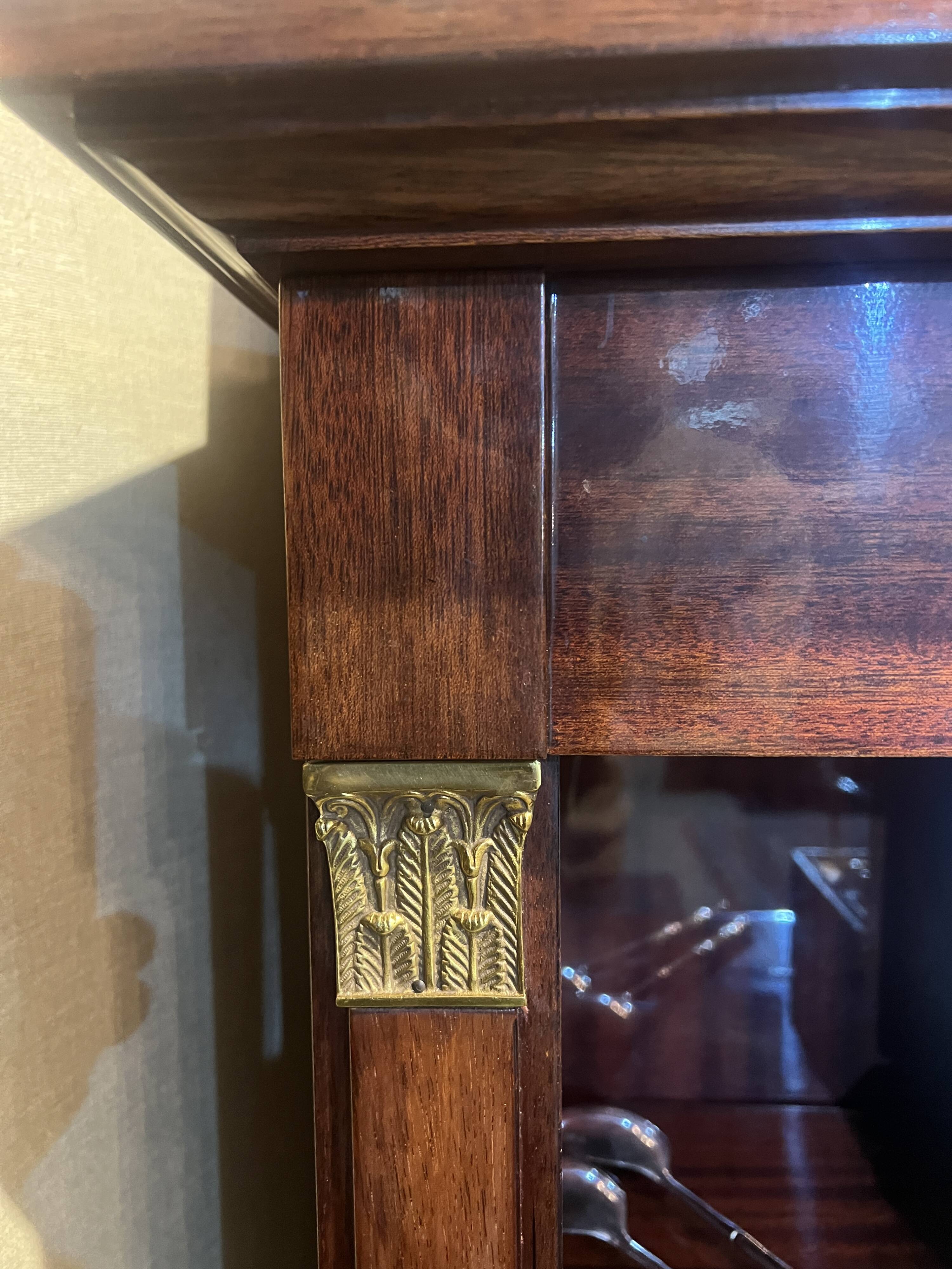 Directoire style bookcase in mahogany, decorated with gilded bronze.