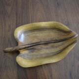 Wooden top in the shape of a leaf