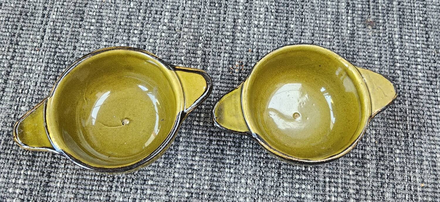 Set of 2 glazed khaki clay bowls.