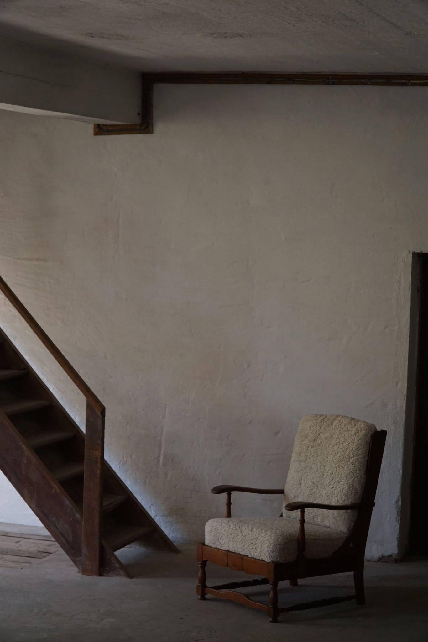 Modern Danish design, a pair of high-backed armchairs in oak and lambswool, 1950s.