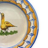 Earthenware plate representing a bird signed Lario