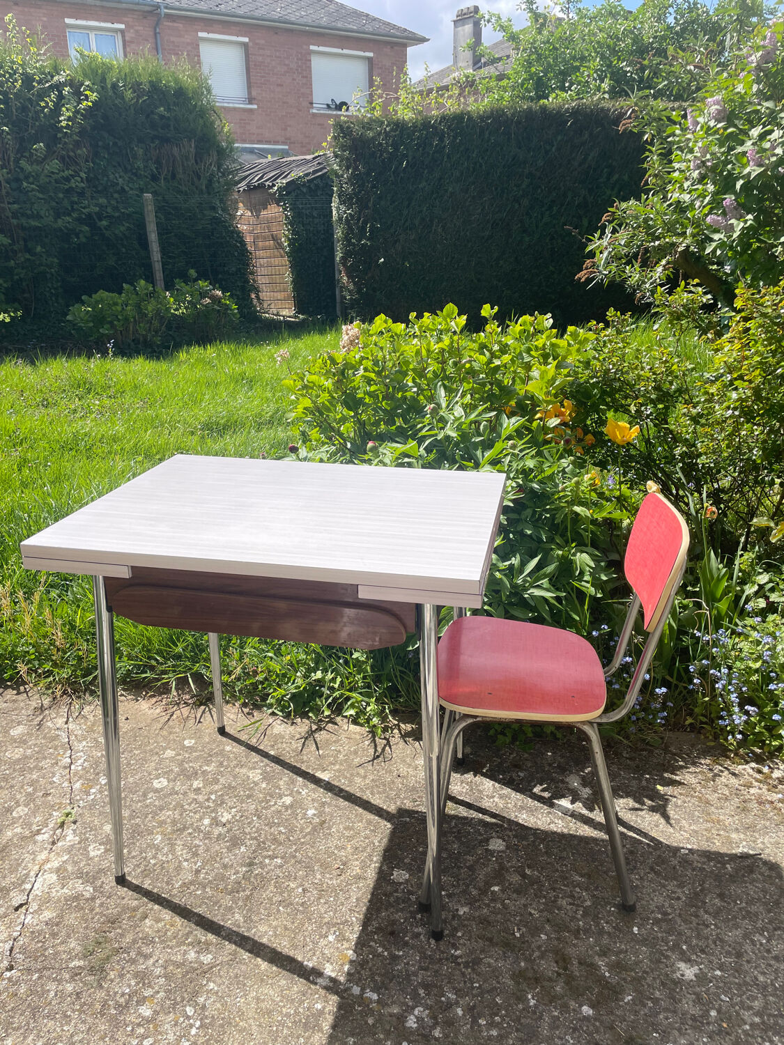 Formica table with a red Mid-century chair.