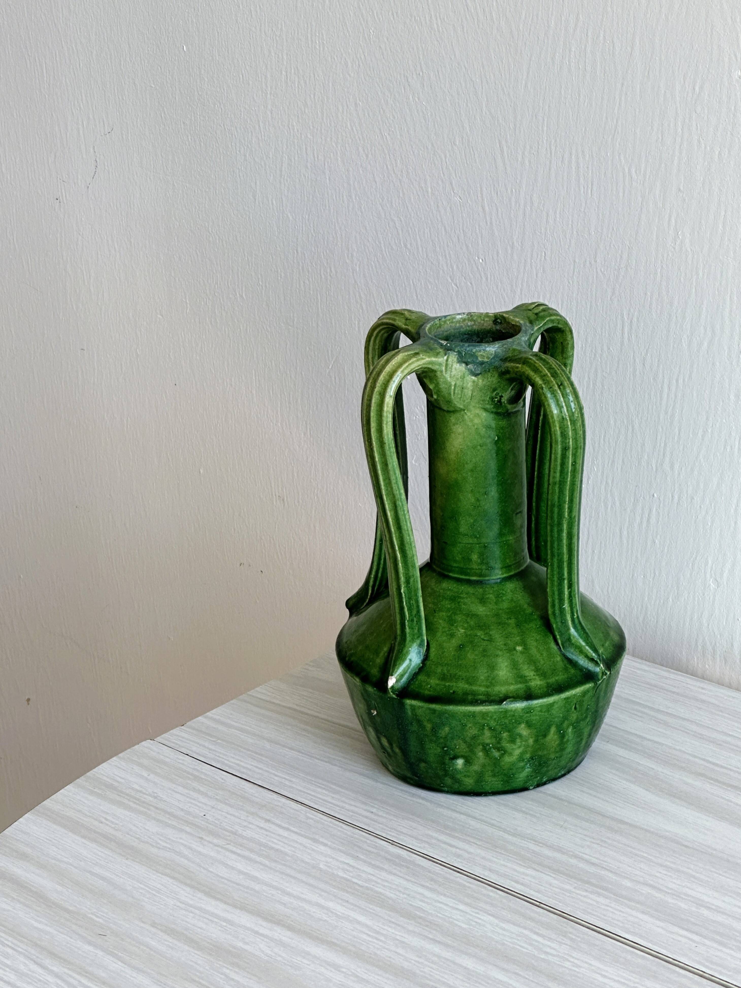 Pottery green ceramic vase with four handles.