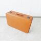 Valise de couleur cognac, valise dure