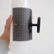 Set of four wall lights in white plexiglass and perforated black metal.