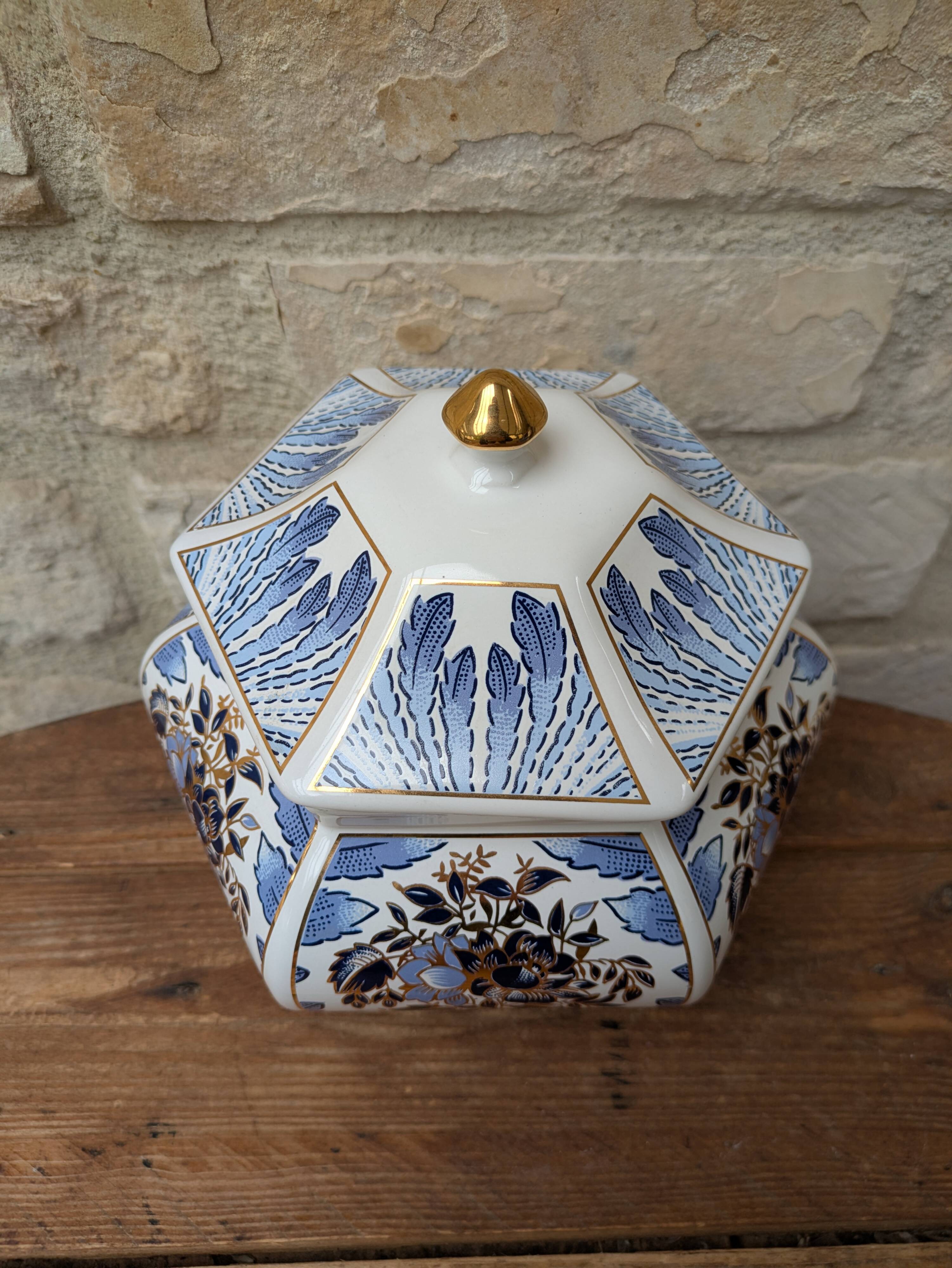 Decorative pot jar with a lid featuring a blue floral pattern and gilding.