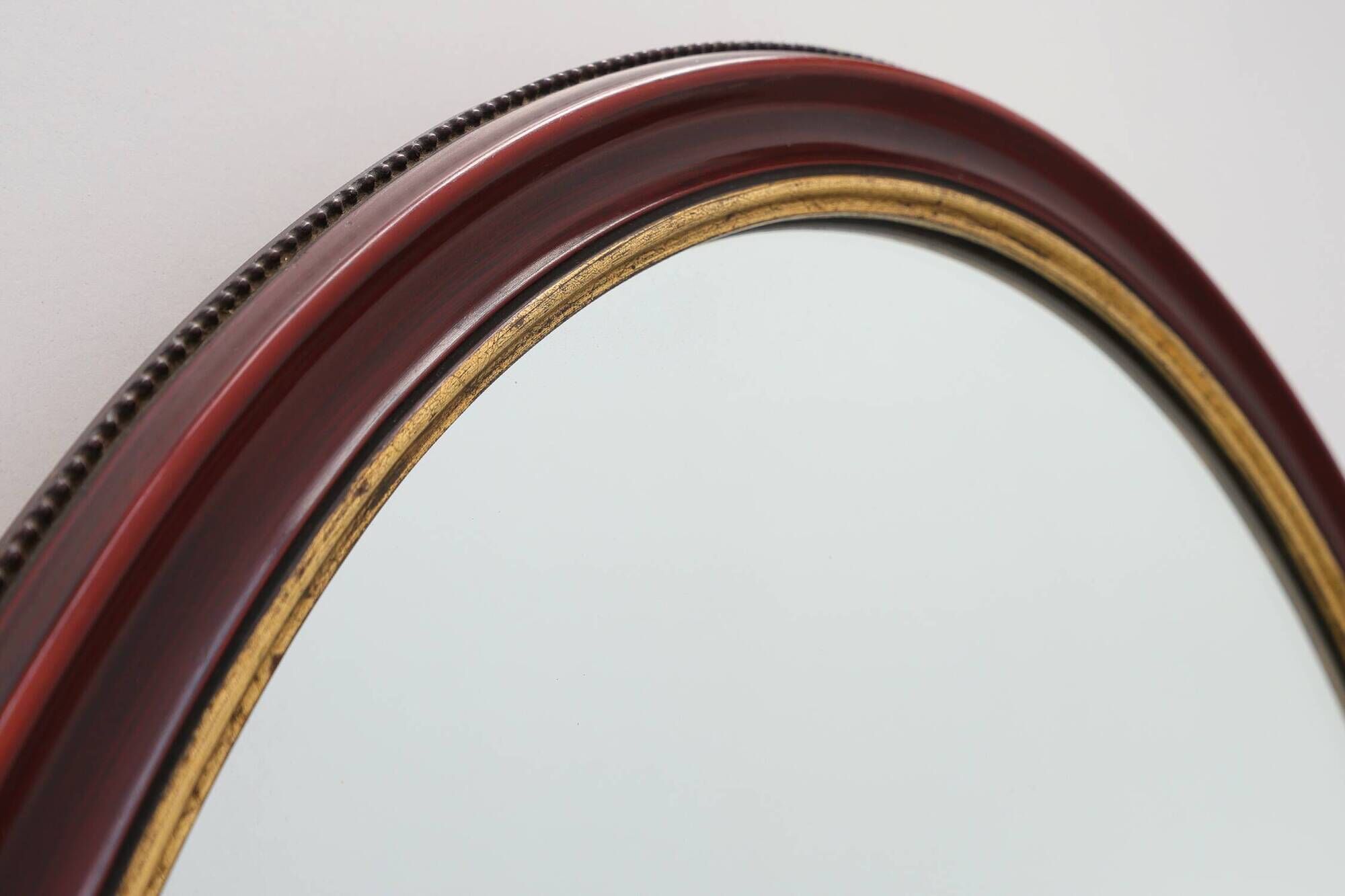 French Burgundy Lacquered Oval Mirror with Gilt Inner Edge, circa 1920