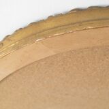 Beveled oval mirror and gilded wood frame